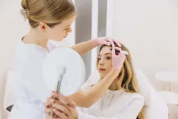 Medical aesthetician administering injectable treatment for cosmetic enhancement