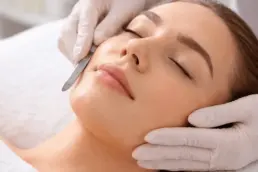 Professional dermaplaning facial treatment removing dead skin and fine hair for smoother, brighter skin